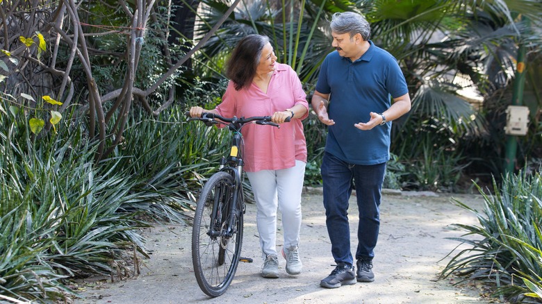 Two people outside with bicycle