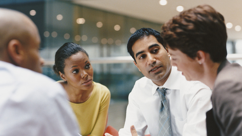 Co-workers engaging in conversation