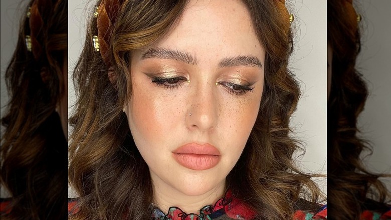 Gold eyeshadow with winged eyeliner