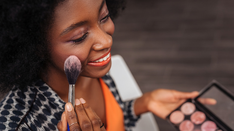 Woman with blush palette