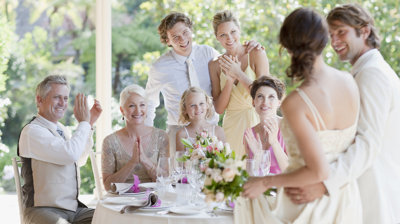Friends and family smiling at wedding
