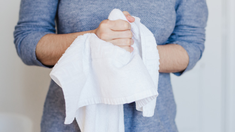 woman drying hands with towel