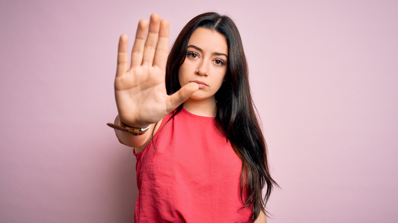 woman holding up her palm