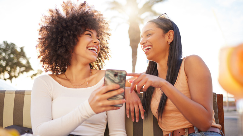 women texting on vacation