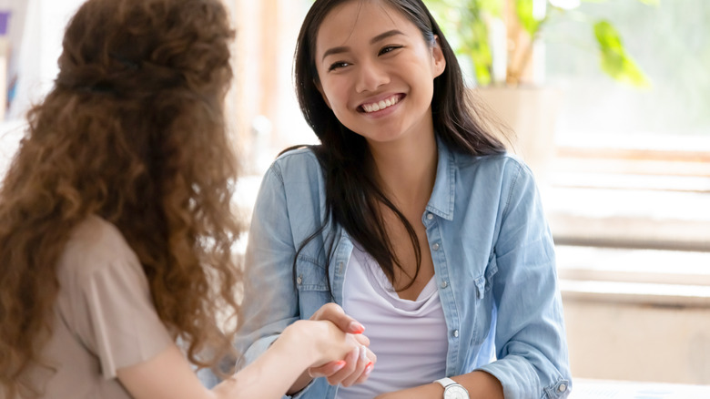 Two women shaking hands