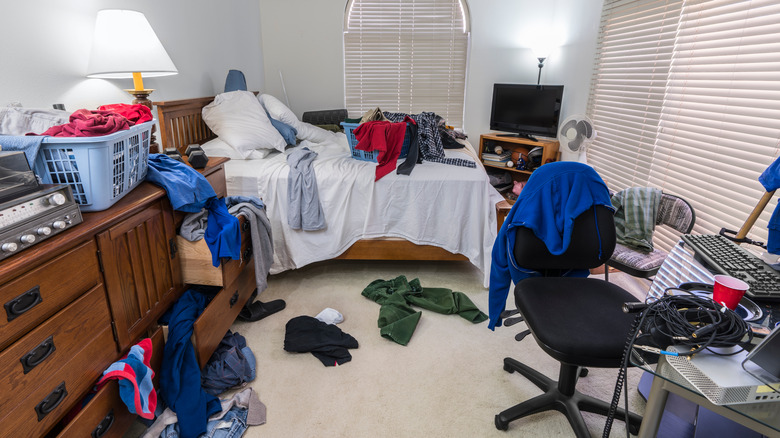 Messy bedroom with clothes everywhere