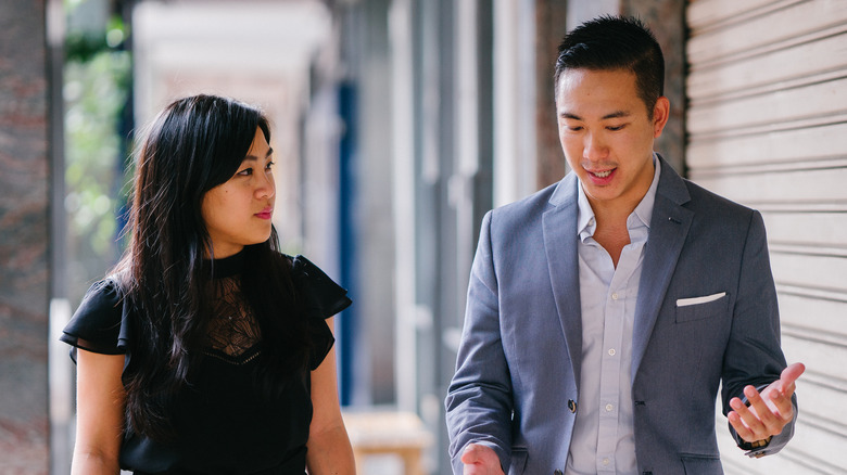Man and woman having discussion outside