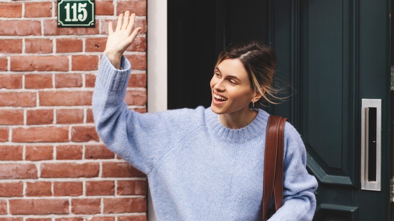Woman waving goodbye