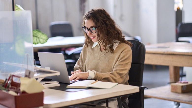 Woman typing at laptop