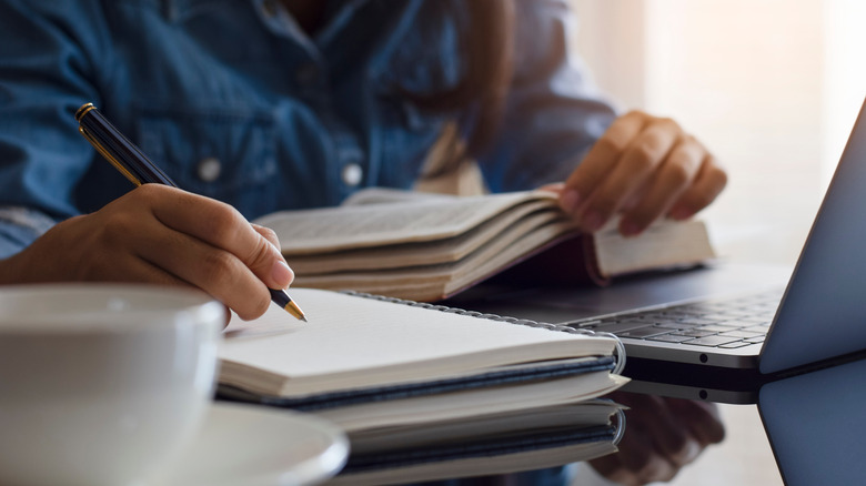 Person writing in notebook