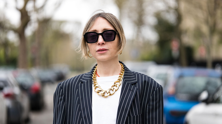 woman wearing gold necklace