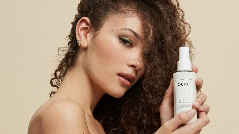 Woman holding oui leave-in