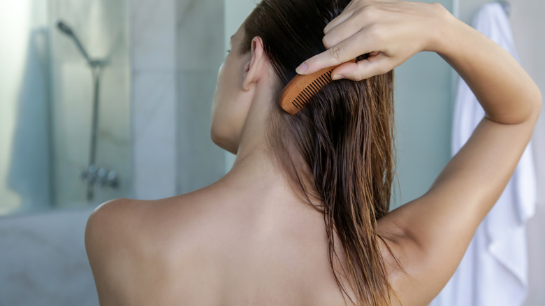 Woman combing wet hair