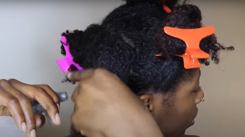 Woman sectioning her hair