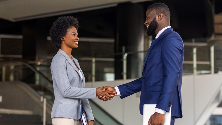 Woman and man shaking hands