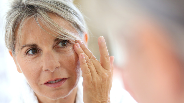 Woman applying eye cream