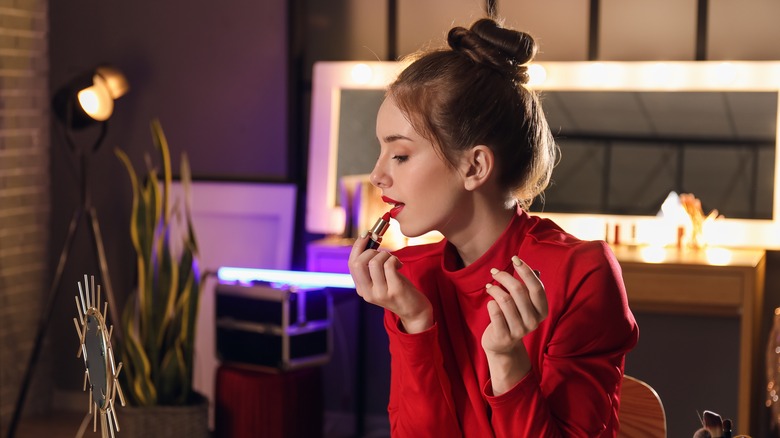 Woman applying lip color