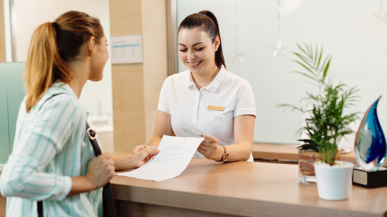 Woman talking to spa facialist