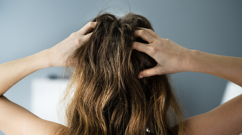 woman scratching scalp