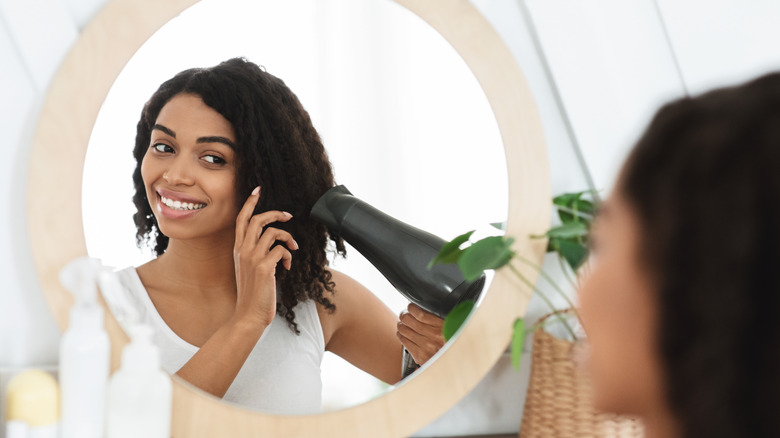 woman blow-drying hair