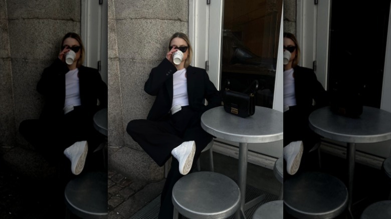 woman wearing blazer and sneakers