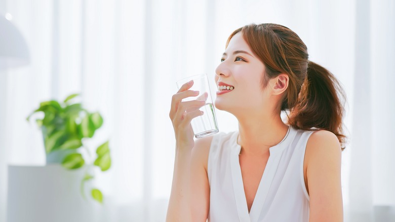 woman holding glass of water