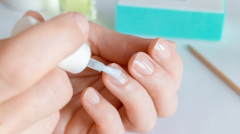 applying nail strengthener to nails