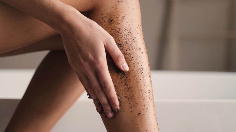 Woman using homemade body scrub