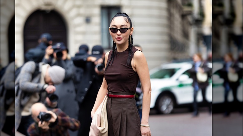 Woman in street wearing brown clothes 