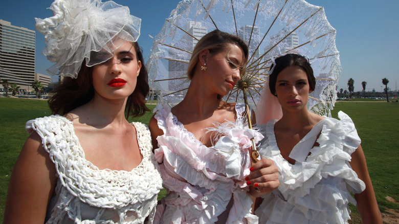 Women dressed in toilet paper dresses