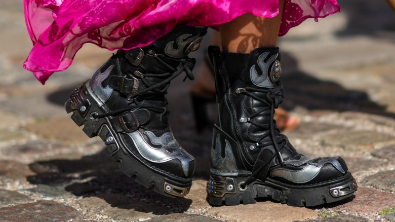 A woman wearing chunky, heavy biker boots