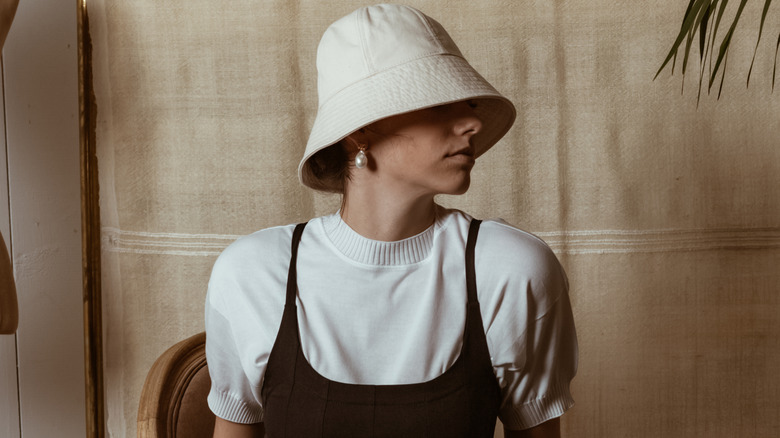 A woman wearing a white bucket hat