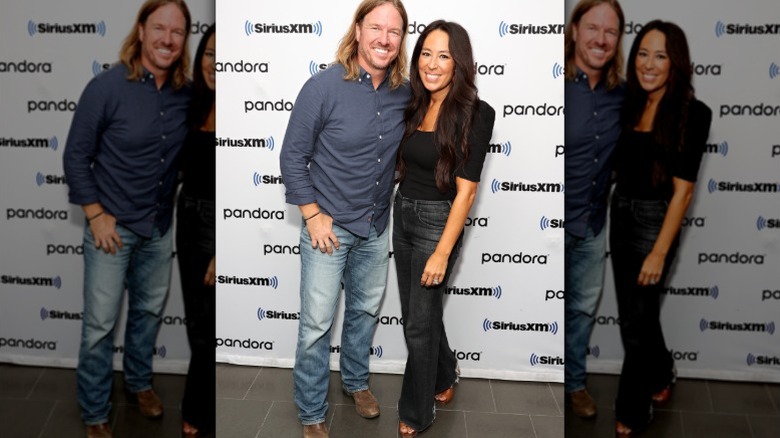 Chip and Joanna Gaines pose at a podcast recording