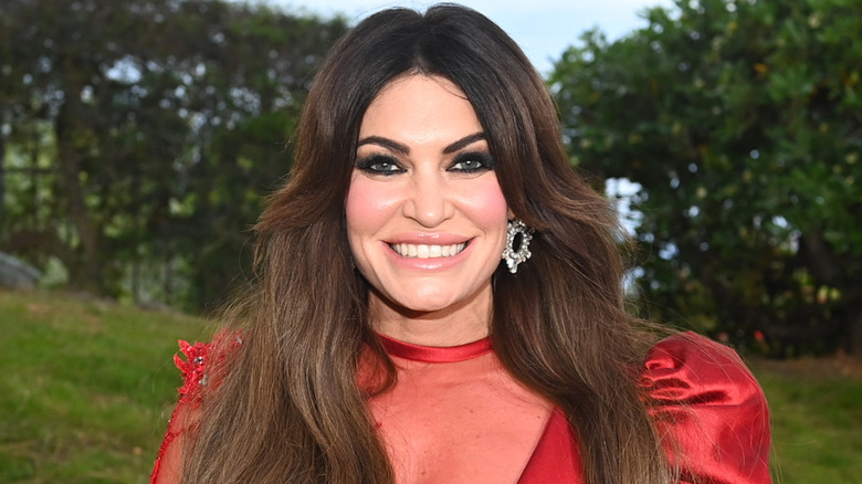 Kimberly Guilfoyle smiling in a red dress