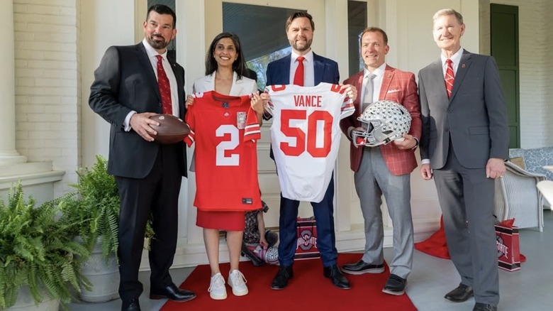 Usha Vance wearing white sneakers and posing behind football jersey