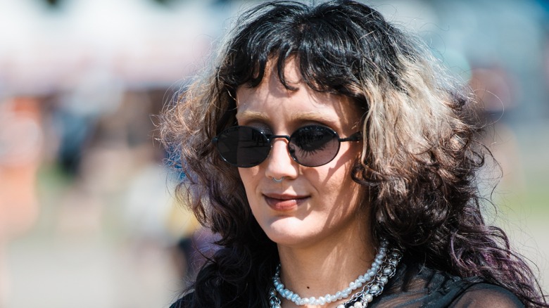 A woman with chunky blond highlights in her black hair
