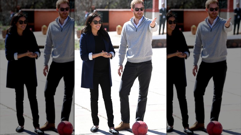 Meghan Markle pictured with Prince Harry wearing an oversized blazer, jeans, and loafers