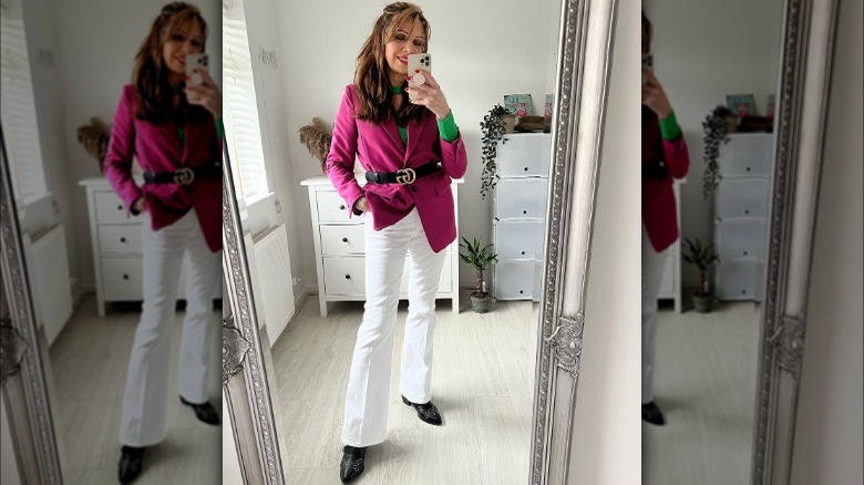 Pink blazer with black belt and white pants