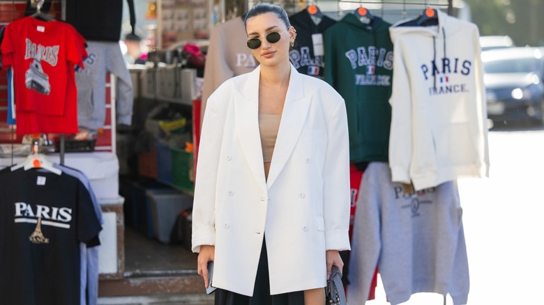 Woman wearing oversized white blazer