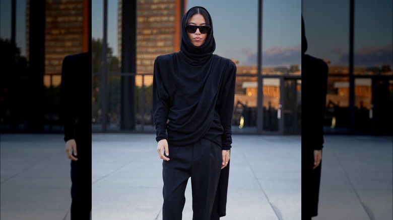 woman wearing hooded shoulder pad top