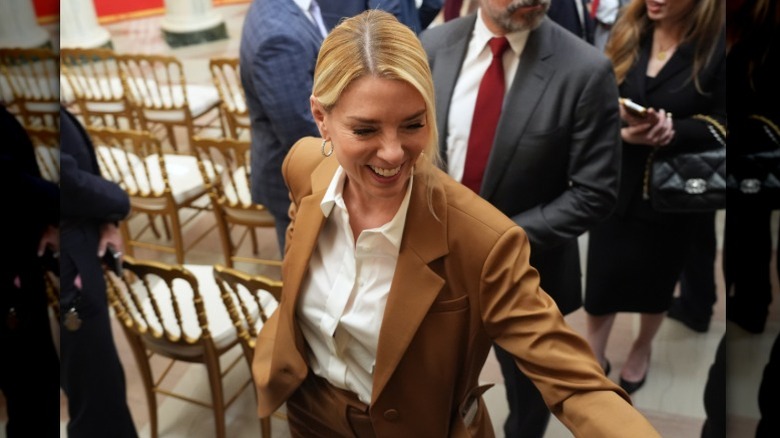 Pam Bondi leaves a press conference at the White House