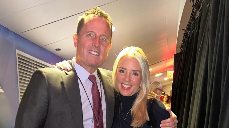 Richard Grenell and Pam Bondi with their arms around each other