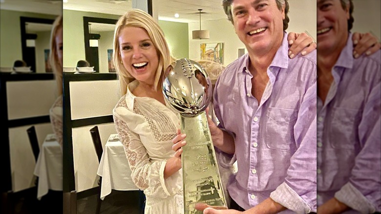 Pam Bondi and her husband John Wakefield hold the Lombardi trophy