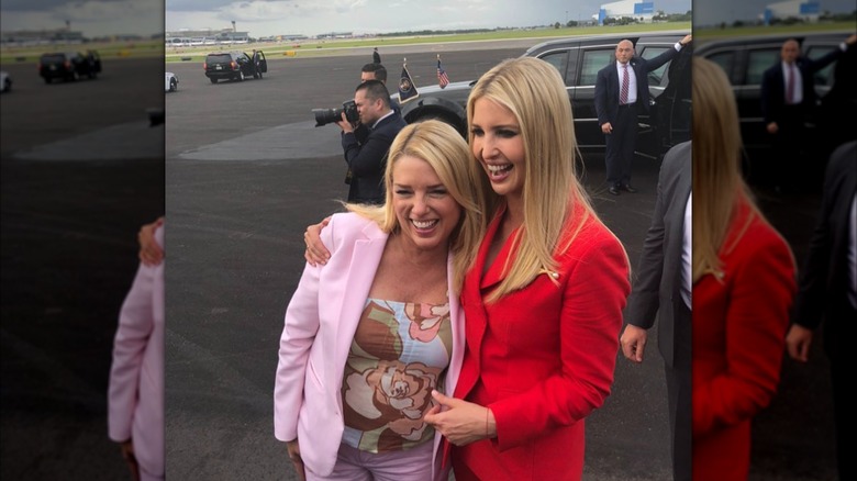 Pam Bondi hugs Ivanka Trump on the tarmac of Air Force One