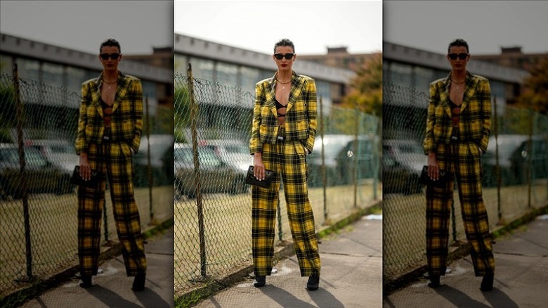 woman wearing bra and plaid suit