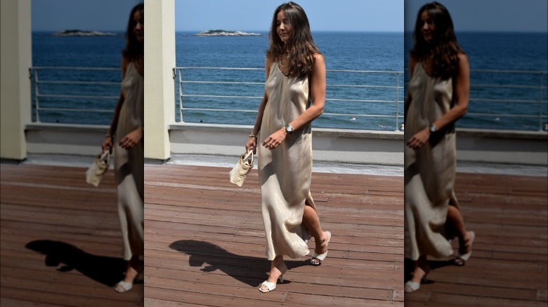 Girl wearing a sleek gold slip dress.