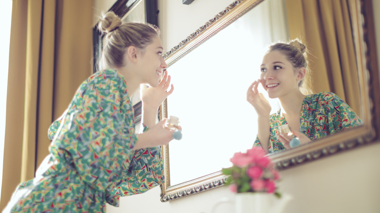 Girl applying foundation with fingers