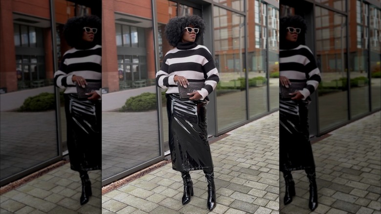 Girl wearing patent boots with a pencil skirt