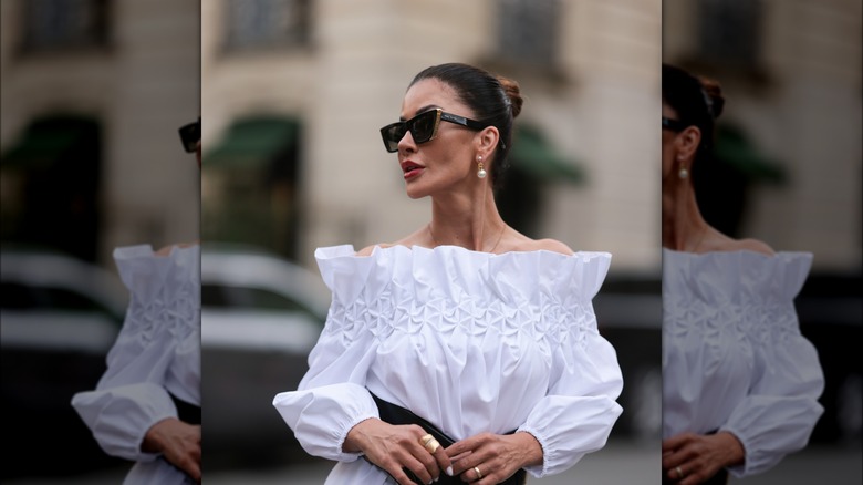 Woman wearing dangly pearl earrings 