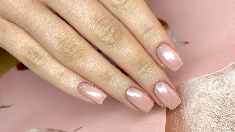 Hand with shiny pearl-inspired nails